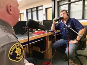 Shawn Boyd listens to Captain Stokes talk about Ghost Ship Fire