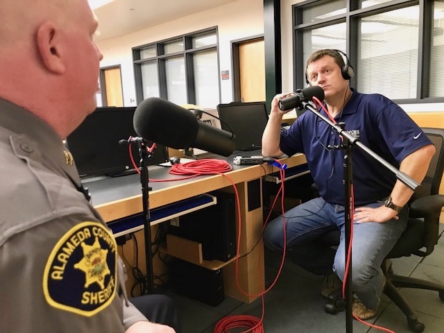 Shawn Boyd listens to Captain Stokes talk about Ghost Ship Fire