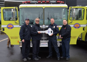 Chief Brian Marshall handing over new engine to North County