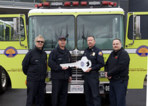 Chief Brian Marshall handing over new engine to North County