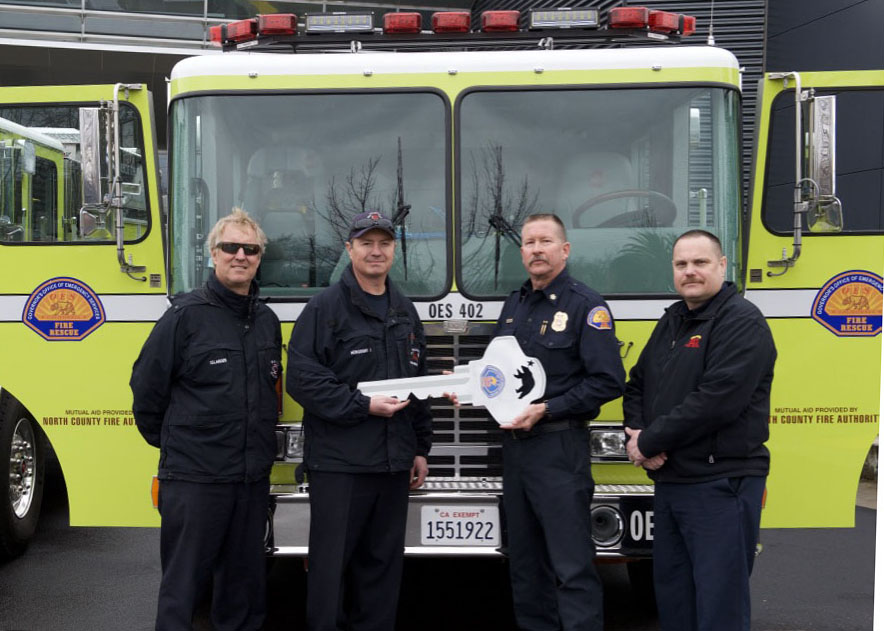 Chief Brian Marshall handing over new engine to North County