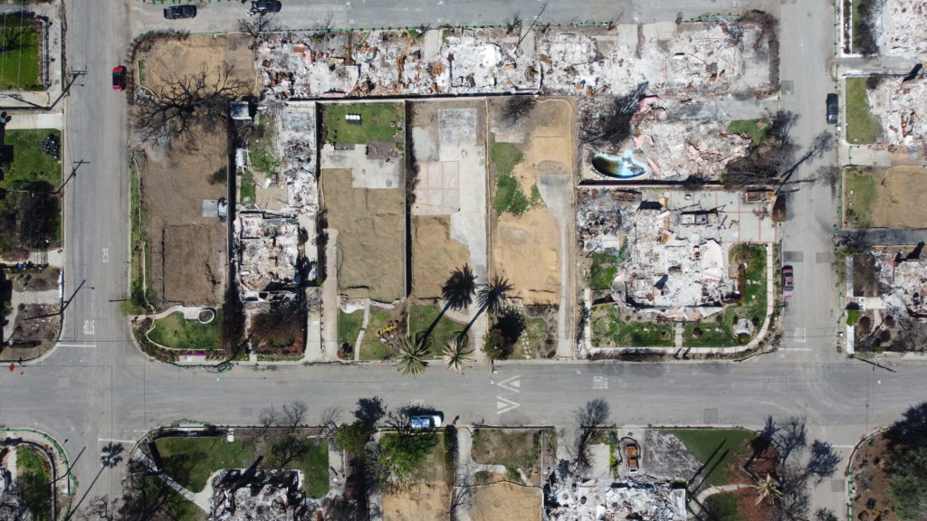 LA fire debris removal progress showing multiple properties cleared of fire ash and debris.