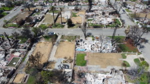 LA fire debris removal progress showing multiple properties cleared of fire ash and debris.