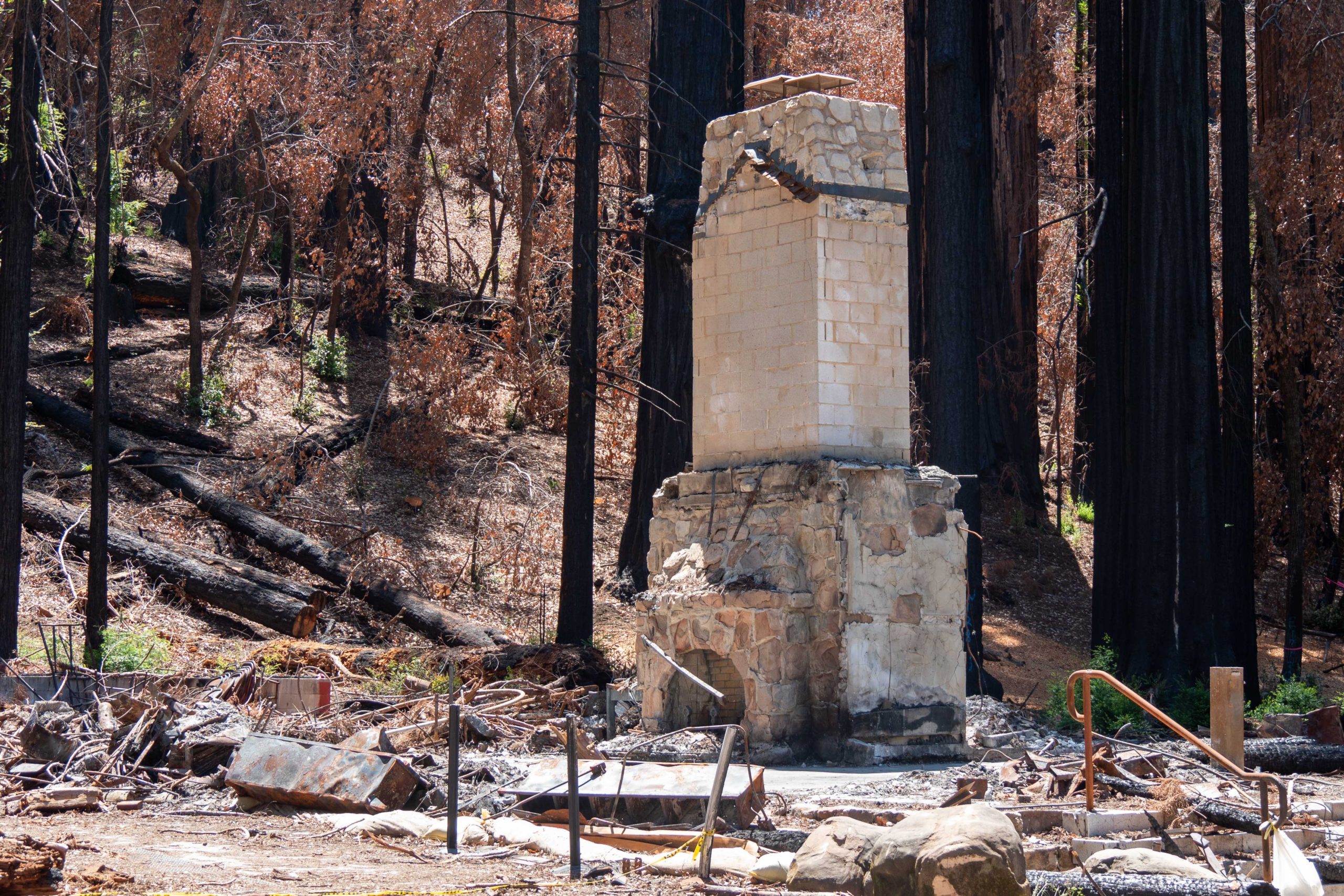 A fireplace and chimney stands after fire