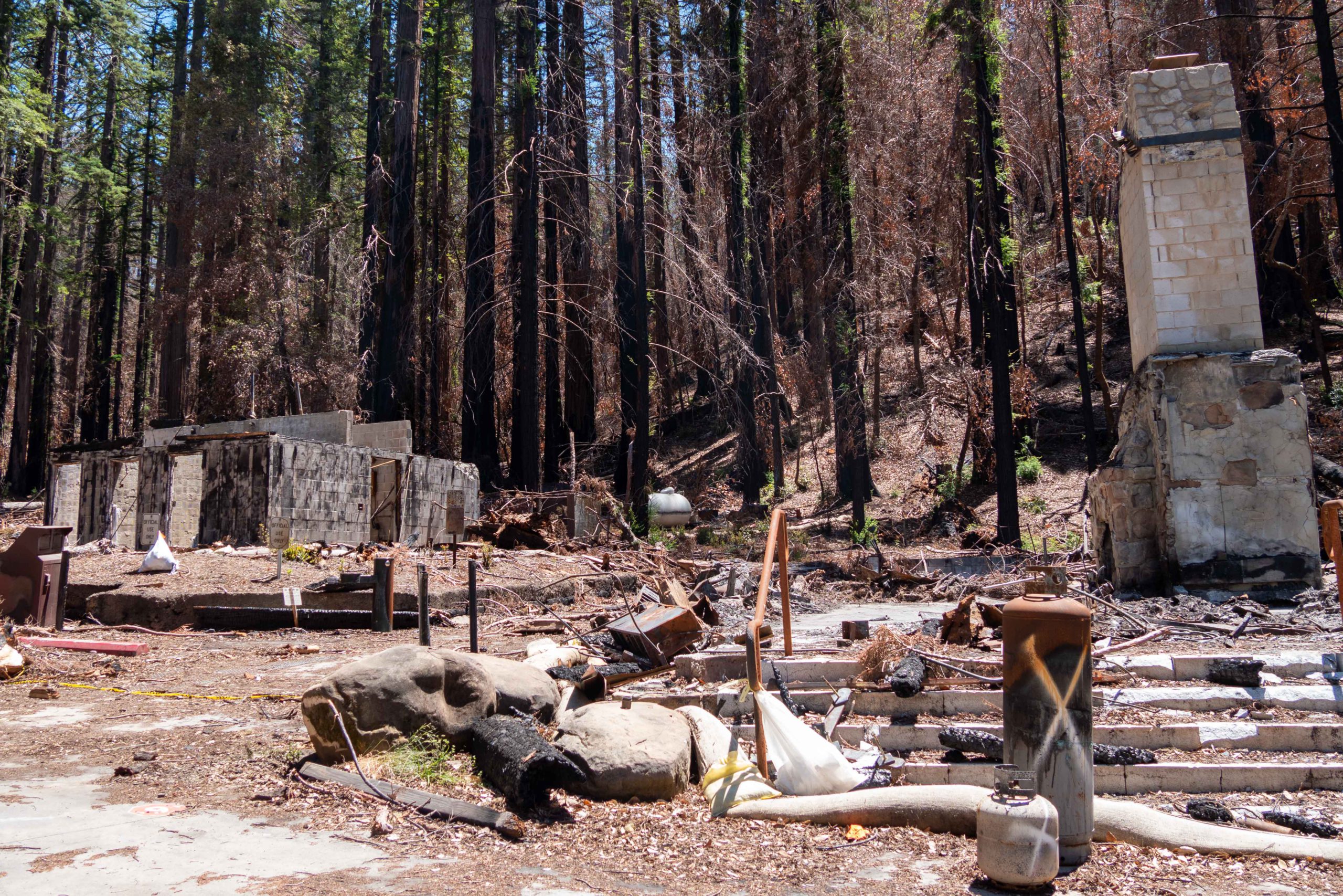 A fireplace and chimney stands after fire