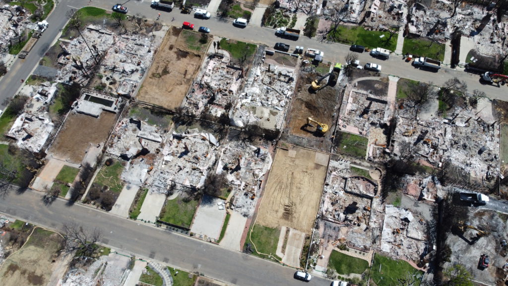 LA fire debris removal progress showing multiple properties cleared of fire ash and debris.