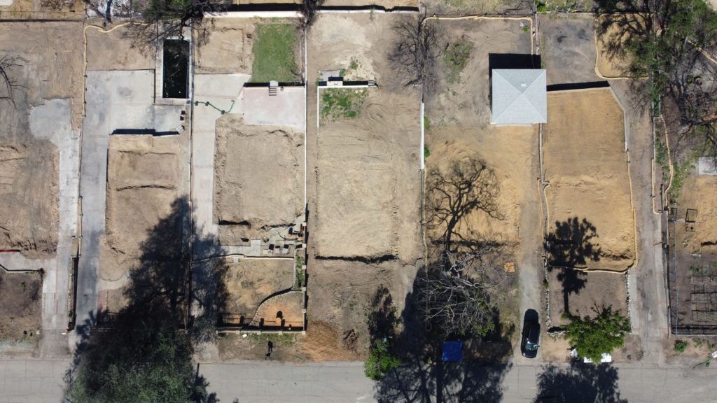 LA fire debris removal progress showing multiple properties cleared of fire ash and debris.